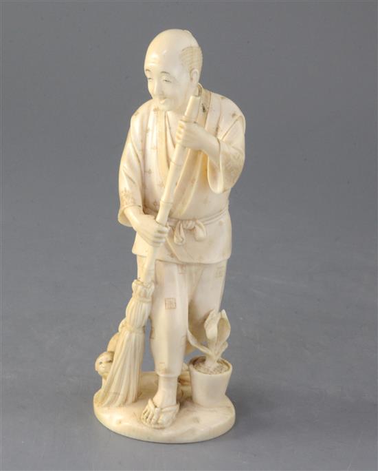 A Japanese ivory okimono of a man and a puppy, early 20th century, height 18.2cm